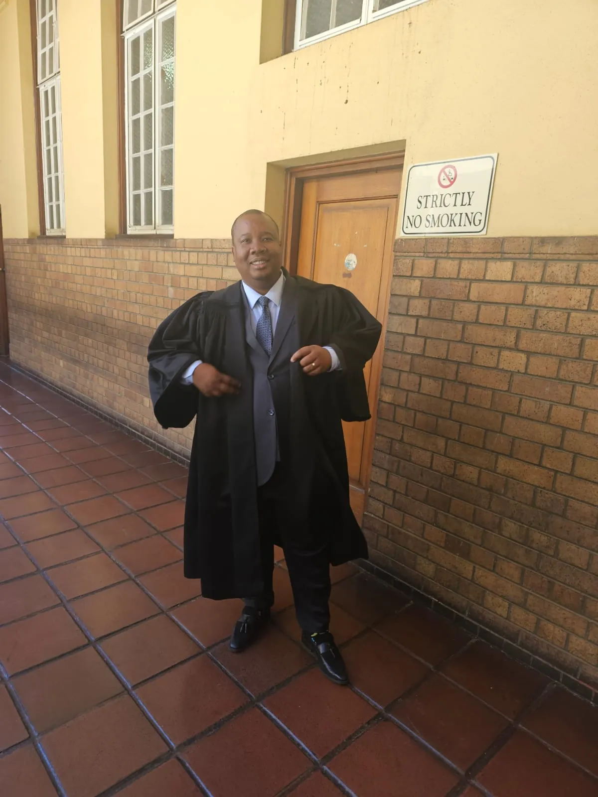 Washington Magampa in court robes outside a courthouse