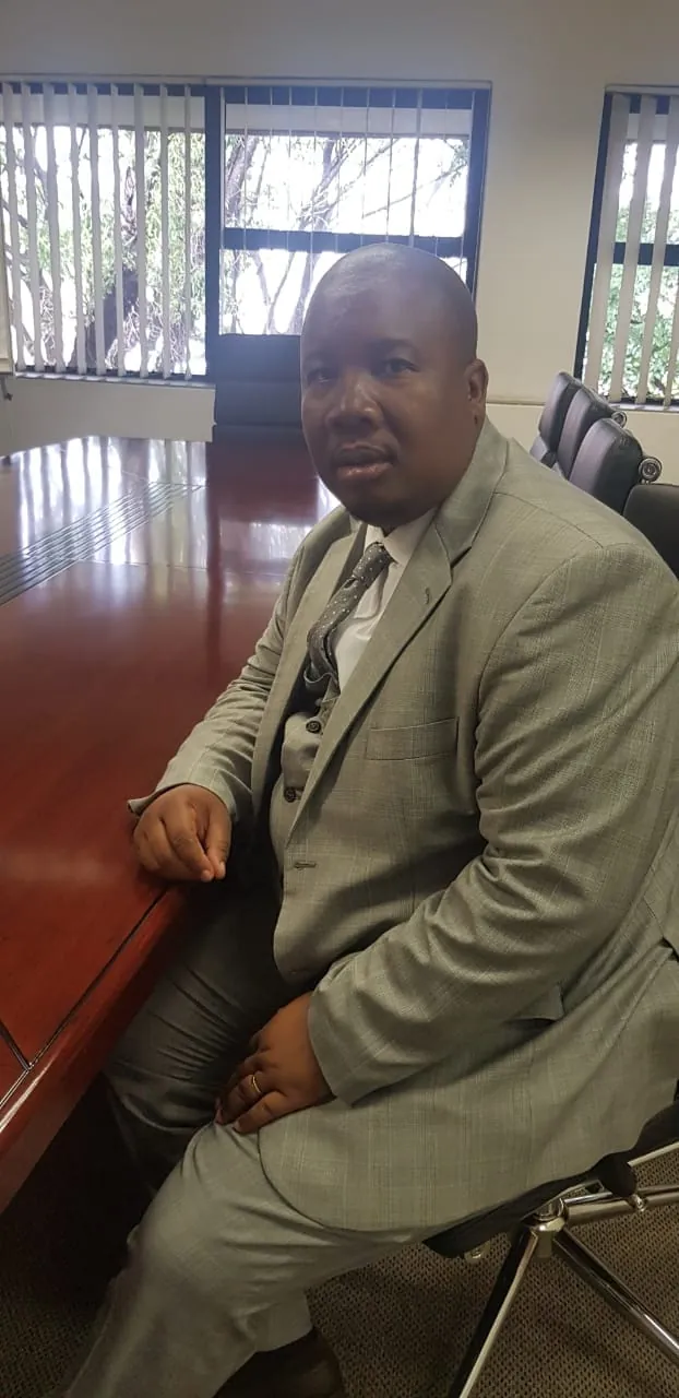 Washington Magampa seated in a courtroom